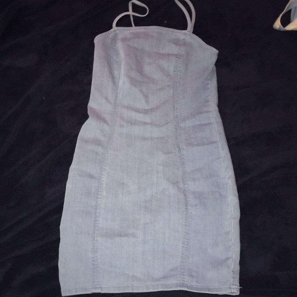 small jean dress ,have scraps , short a little ., stretchy ,light blue color .